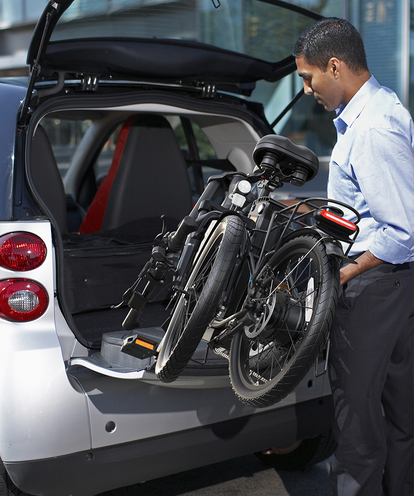 The man is folding the bike