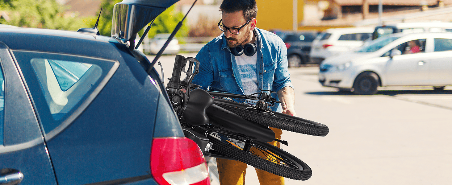 The man putting the folding mountain ebike into the trunk