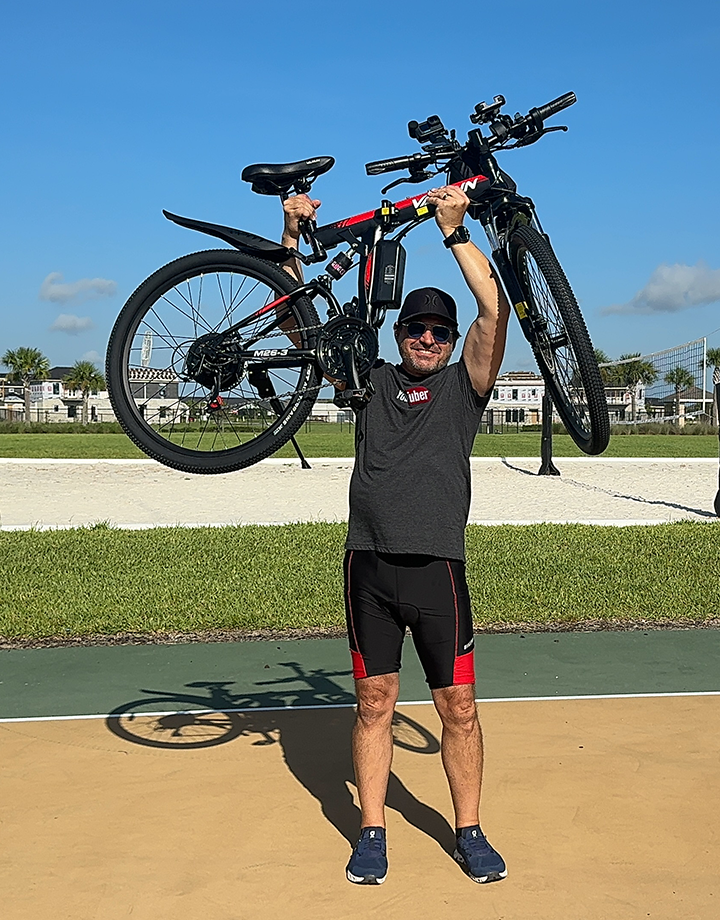 The man holding the ebike up.